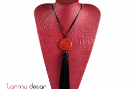 Necklace designed with red round pendant and black tassel